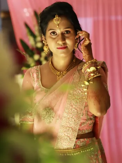 A direct portrait of the bride on her engagement day. The makeup is designed to look flawless in professional photos, with a focus on creating a smooth, radiant complexion.