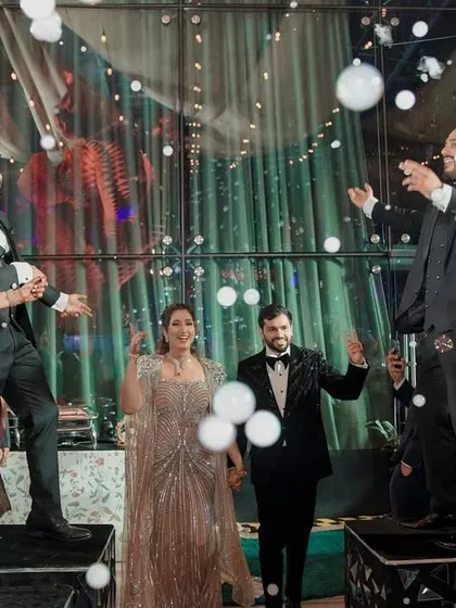 When the couple's energy is electric, their entry should be too. I designed this fun flashmob entry where friends and family danced on platforms, surrounded by bubbles, to bring in the happy couple.