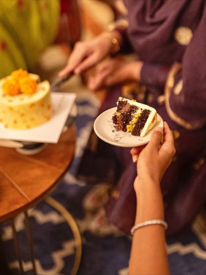 A perfect slice of our Chocolate, Orange & Marigold Diwali cake, showing the rich layers of chocolate mousse, orange pastry cream, and marmalade.