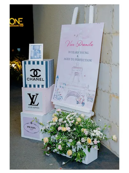 The welcome area for a "Parisian Luxury" 70th birthday. We used custom signage and props inspired by high-fashion brands to immediately introduce the chic and celebratory theme.