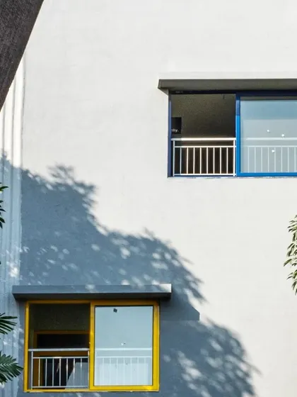 At L'Atelier at Greenwood High Campus, we used pops of color in the window frames to add a playful element to the facade, reflecting its function as an art and music school.