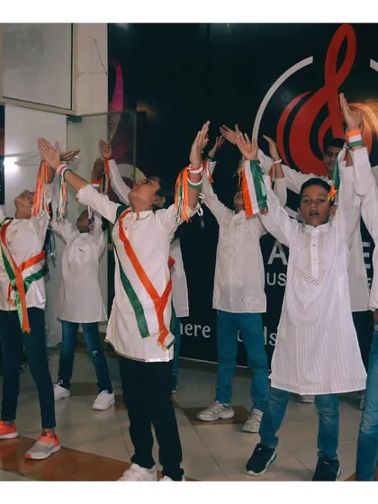 A group of boys in the final pose of their patriotic dance, showing unity and spirit during a celebration at our studio.