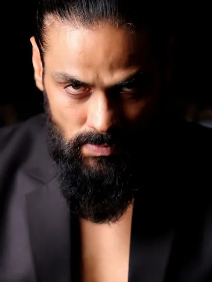 Using shadow to create drama, this portrait of Arpit Ranka is all about mystery and intensity. Half of his face is obscured, drawing all the attention to his powerful gaze.
