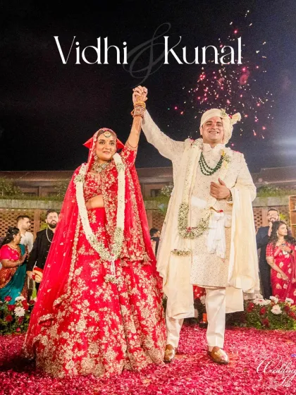 Pure celebration. The bride and groom raise their hands in triumph after the varmala ceremony, a perfect candid shot filled with happiness and the promise of a shared future.