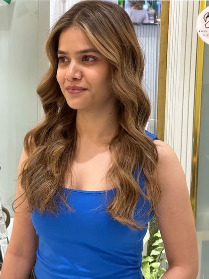 The client looking chic and happy with her new honey brown hair.