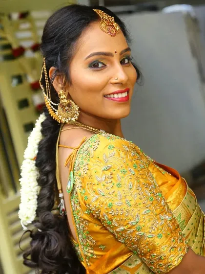 A bright and happy look for Deepu's housewarming ceremony. The makeup is festive, with a pop of color on the lips.