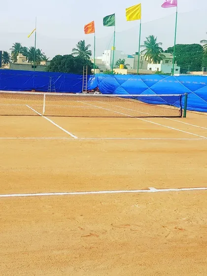 Here is a clear view of our tournament-ready clay court on a bright day. We keep the lines sharp and the surface perfectly prepared, so you get a consistent and professional playing experience every single time.