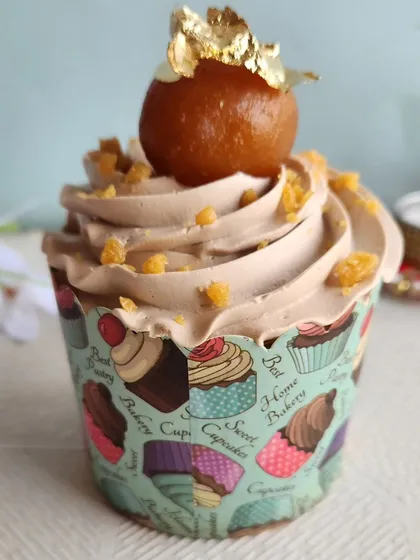 This is our Gulab Jamun Cupcake, a perfect example of our fusion creations. We place a whole gulab jamun on top of a swirl of spiced buttercream, creating a delightful mix of traditional Indian sweets and classic baking.