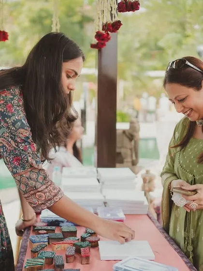 Guests fully engaged at the block-printing station, carefully creating their own personalized keepsakes from the wedding.