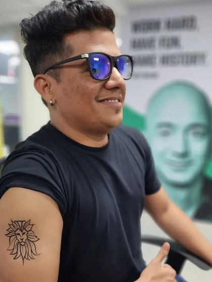 A temporary tattoo of a lion's head with a floral mane, perfect for a corporate event.