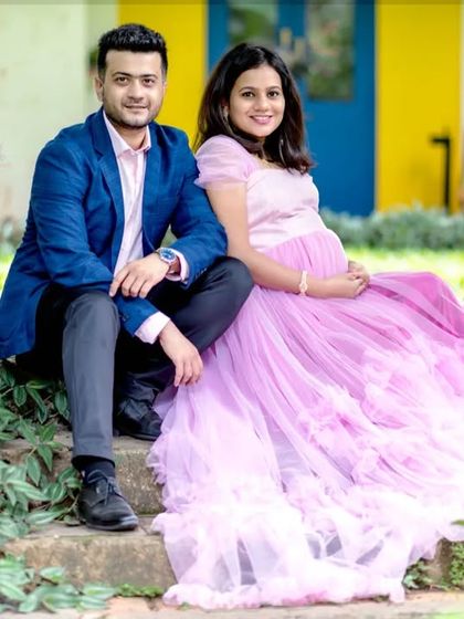 A coordinated couple's maternity shoot. The partner's blue blazer is a great match for the light purple doll gown, creating a stylish and modern look.