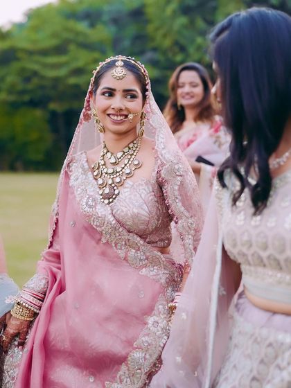 A happy bride surrounded by her friends. This photo captures the joy of the day. The makeup is fresh and radiant, ensuring the bride looks her best while enjoying every moment.