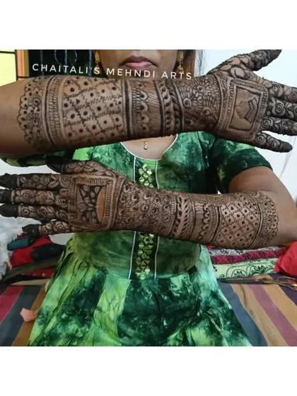 The back of the hands for a simple bridal mehendi. The design features geometric patterns and personalized name blocks for a clean and modern look.