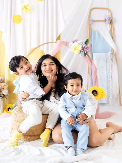 Pure joy during a Mother's Day mini session. A mother laughs with her two sons, creating a memory filled with love and happiness.