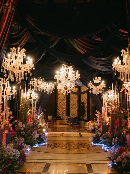 A masquerade sangeet at the St. Regis Mumbai, where royal elegance met a touch of mystery. The entrance, draped in deep velvets and lit by magnificent chandeliers, set the stage for a night of magic, music, and dancing.