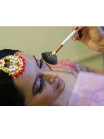 A close up of the makeup application process. I'm using a fan brush to lightly dust on highlighter for that perfect, ethereal glow.