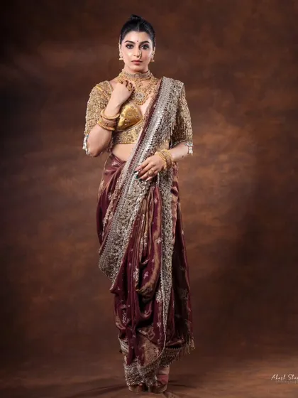 A full-length view of the stunning bridal saree. The pose is strong and confident, showing the complete look from head to toe.
