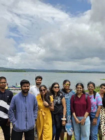 A group photo by the serene waters of the Harangi backwaters in Coorg. It's a peaceful spot to relax and enjoy the scenery.