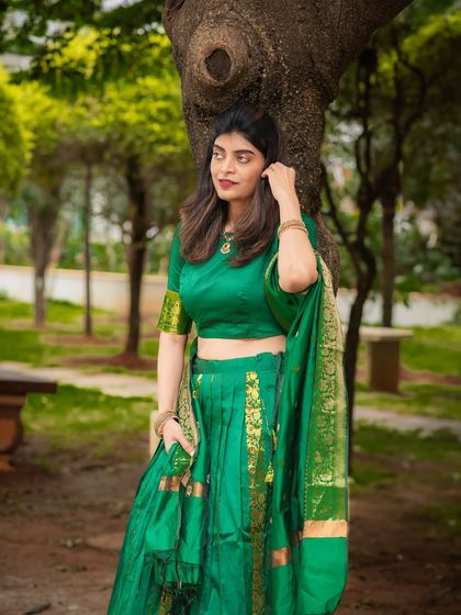 A full-length view of the elegant green saree in an outdoor park setting. I capture both close-ups and wider shots to showcase the complete look.
