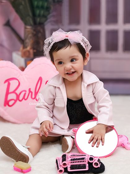 Getting ready for her close-up in the Barbie dream house. This shot captures the fun of playing dress-up with all the themed accessories.