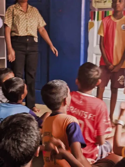An overhead shot of a storytelling session, showing children gathered around a volunteer. This perspective highlights the sense of community and shared experience that defines our work.