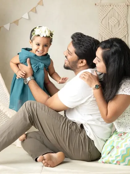 Family photos are about capturing love in action. In this boho-themed session, a candid moment of laughter between parents and their child tells a beautiful story of their family's bond.
