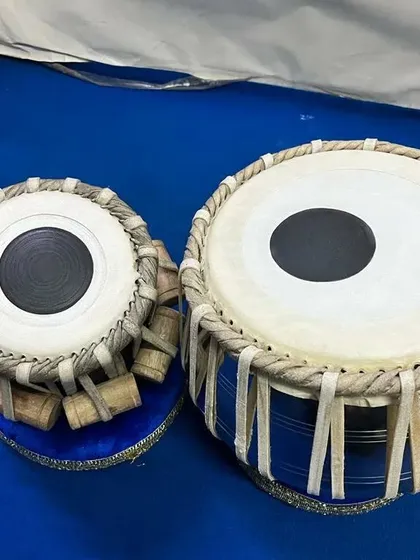 This professional tabla set by features a striking blue wooden bayan. We check the tonal quality of every instrument to ensure it meets the needs of both students and professional performers.