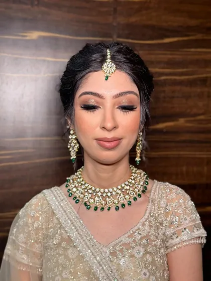 A close-up of Kanika's eye makeup, showing the soft brown and gold tones that create a sophisticated and timeless look.