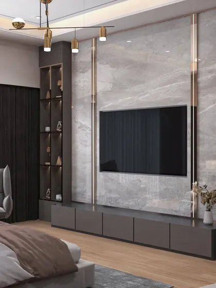 This bedroom TV unit combines a marble-finish feature wall with dark wood shelving and integrated lighting. It provides a cinematic experience while maintaining a cohesive and luxurious bedroom aesthetic.