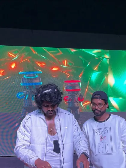 On the decks with my partner, surrounded by the cool visuals of the college fest stage.