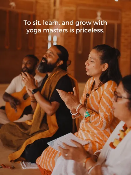 To sit, learn, and grow with yoga masters is a priceless experience. Here, students and teachers engage in kirtan, the practice of devotional chanting, accompanied by a guitar.