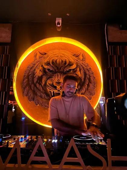 Spinning a set at Badmaash in Koramangala, with their signature tiger logo glowing behind me. The venue's decor adds so much to the overall vibe of the night.