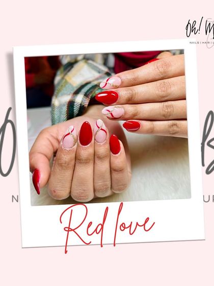Valentine's vibes in Panchkula. This design features a mix of solid red nails and accent nails with abstract red line work over a neutral base.