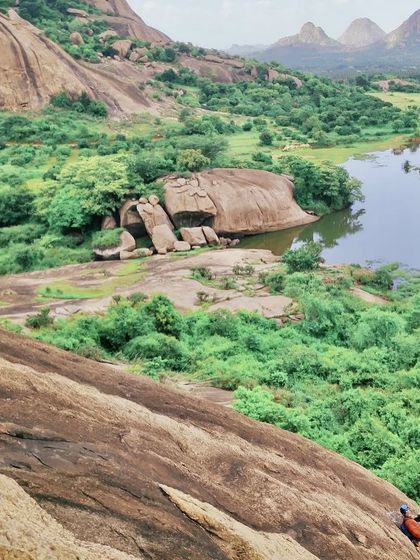 A breathtaking view from a multi pitch route, with climbers visible on the slab below. This is the reward for the long climbs: unparalleled perspectives and a sense of scale.