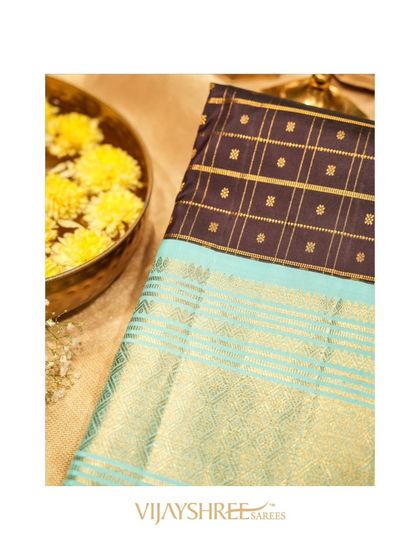 The rich texture and color combination of the black and blue Kanjivaram.