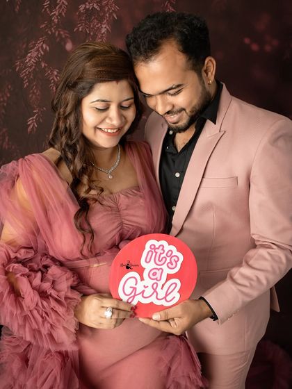 "It's a Girl!" This photo captures the happy announcement with a bright, cheerful prop, celebrating the little princess on her way.