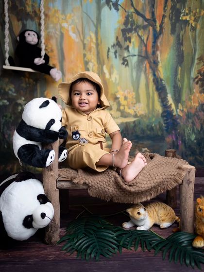 Welcome to the jungle! This little explorer is all set for an adventure in his safari outfit, surrounded by friendly pandas and lions.