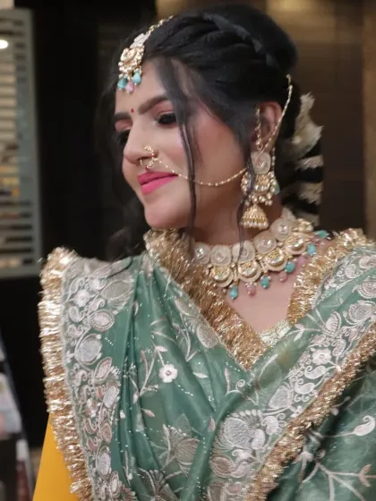 A closer look at the jewelry and makeup for a Punjabi bride, featuring a statement maang tikka and nath.