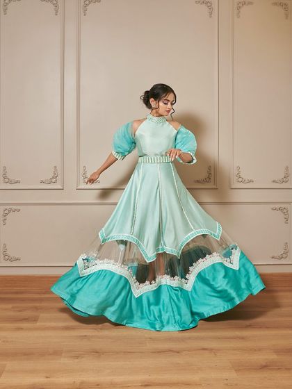 A full-length shot of the 'Jasmine' gown, showing how the skirt creates a beautiful flare. The color is perfect for daytime events like a mehendi or sangeet.