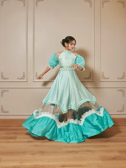 A full-length shot of the 'Jasmine' gown, showing how the skirt creates a beautiful flare. The color is perfect for daytime events like a mehendi or sangeet.