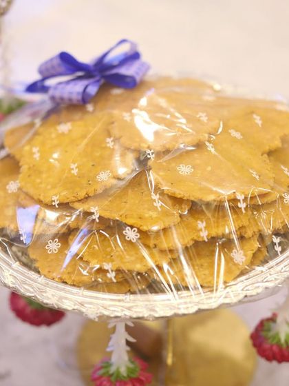 A plate of thattai, a popular South Indian savory snack, neatly packed for a function. I ensure all food items are presented in a clean and attractive manner.