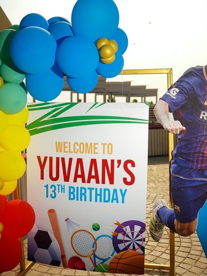 A welcome sign for a 13th birthday sports party, featuring a cutout of Lionel Messi.