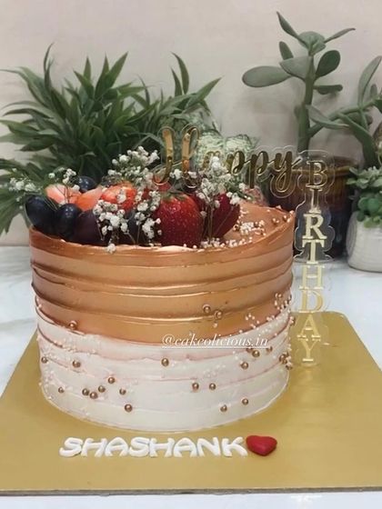 A beautiful airbrushed cake in rose gold, topped with fresh strawberries and grapes. This was one of the last fresh fruit cakes of the season.