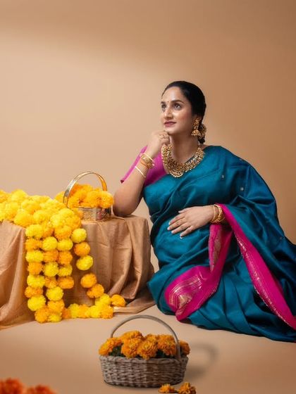 Anticipation and joy. In this serene moment, our beautiful mumma-to-be embodies the essence of pregnancy in a gorgeous blue and pink silk saree.