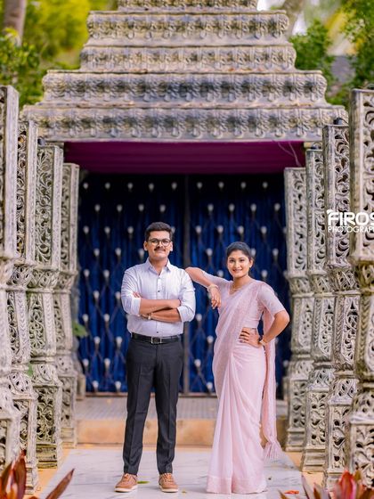 A stylish couple poses in front of our stone pillar structure, a backdrop that adds a touch of ancient grandeur.