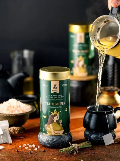A pour shot of Hindraj's Soulful Sultana tea into a dark, elegant mug. The action of the pour and the steam rising from the cup create a dynamic and comforting image, perfect for a tea lover.