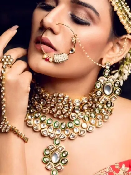 An artistic shot of a model wearing a Pachi Kundan set, highlighting the hathphool and nath.