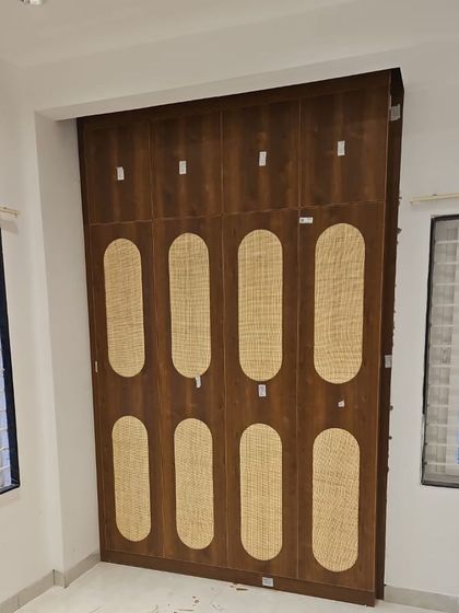 This custom wardrobe features a unique design with wood and cane-panelled doors. The natural textures add warmth and a touch of bohemian charm to the bedroom.