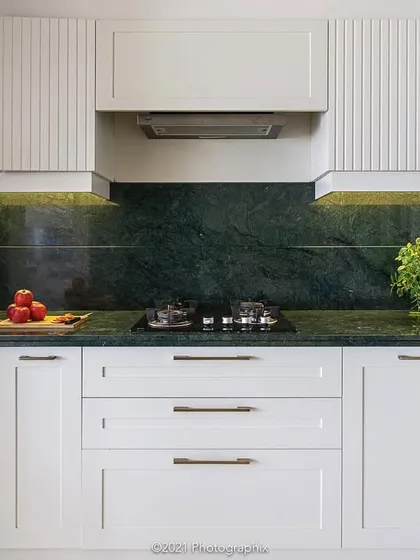 This kitchen design proves that simplicity can be the ultimate sophistication. We paired clean white cabinetry with a rich green marble countertop and backsplash, creating a look that is both timelessly elegant and highly functional for everyday life.