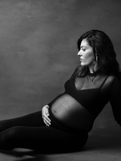 A pensive and artistic floor pose. The deep shadows and soft highlights in this monochrome image create a very moody and beautiful effect.